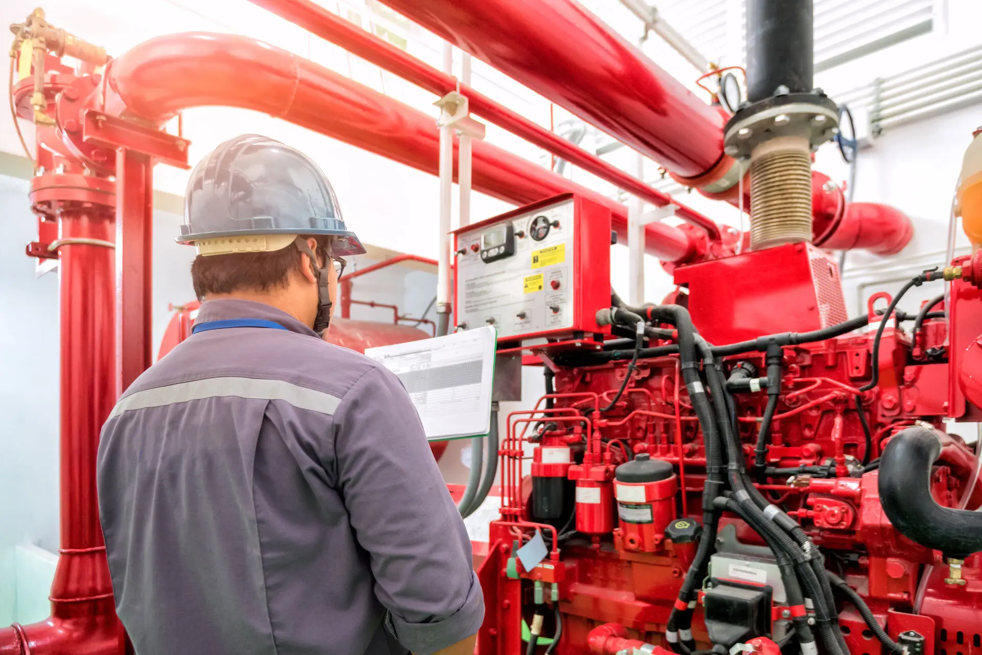 worker testing fire pump