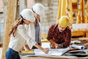 2 lady worker and one mal eworker working on construction site